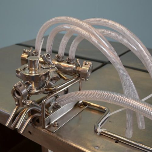Filamatic Model DAB100 (4) Head Bench Top Inline Piston Filler with 12 Pumps